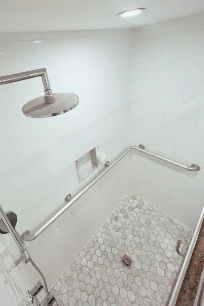 A top view of a shower with grab bars for handicap use.
