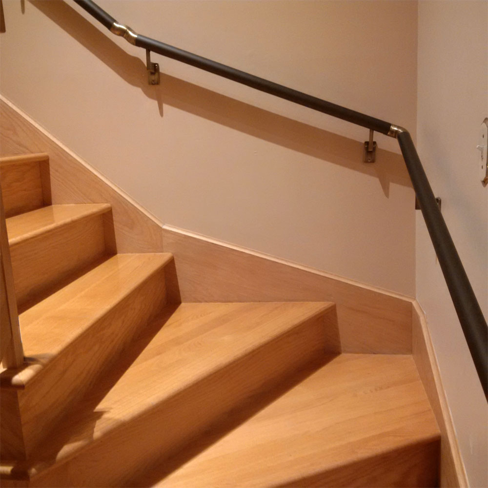 Stairway handrails installed on the wall.